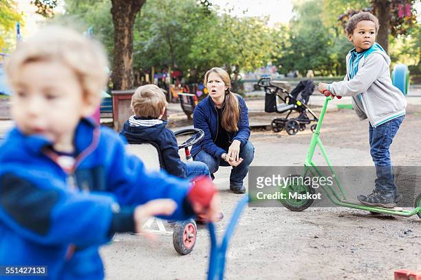 angry teacher with children playing on playground - nursery school child stock pictures, royalty-free photos & images