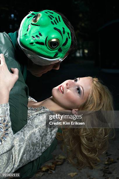 frog prince seducing young woman - froschkönig stock-fotos und bilder