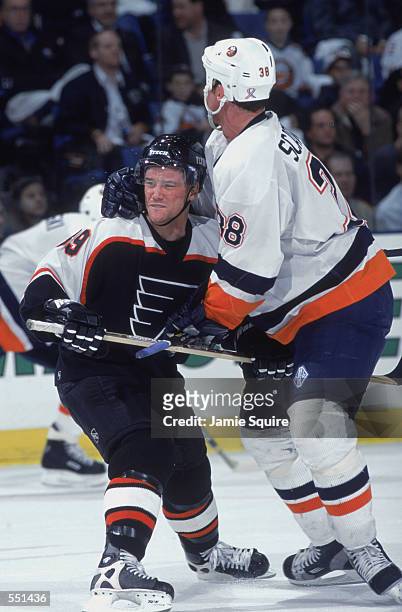 Centers Marty Murray of the Philadelphia Flyers and Dave Scatchard of the New York Islanders battle for position during the NHL game at the Nassau...
