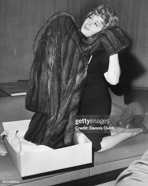 Actress Shelley Winters happily inspecting her new Labrador mink coat, during rehearsals for the television play 'Mr Bixby and the Colonel's Coat',...