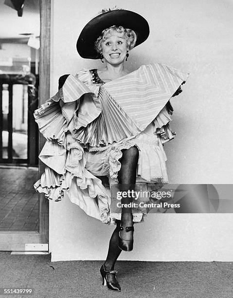 Portrait of actress Barbara Windsor in costume, rehearsing a dance routine for the musical 'Sing a Rude Song', London, February 16th 1970.