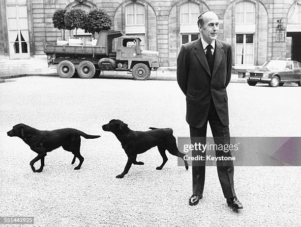 French President Valery Giscard D'Estaing with his two labradors in the grounds of the Elysee Palace, with a military truck in the background, Paris,...