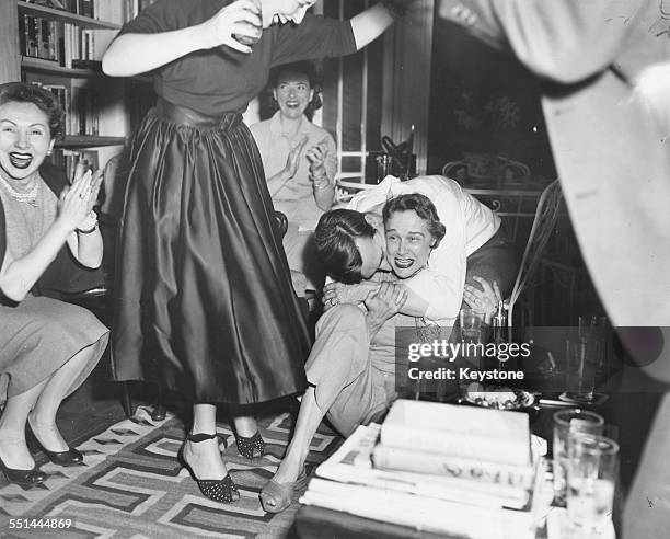 Actress Kim Hunter being hugged and kissed by her husband Robert Emmett, as they celebrate her 'Best Actress' Academy Award win, at their home in...