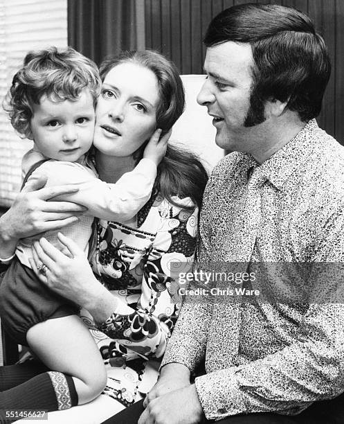 Irish broadcaster Terry Wogan with his wife Helen and baby son Alan, circa 1975.
