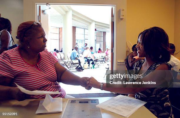 New Orleans evacuee Lynn Hayes thanks Dallas Housing Authority employee Dana Henley for helping her find an apartment September 6, 2005 in Dallas,...