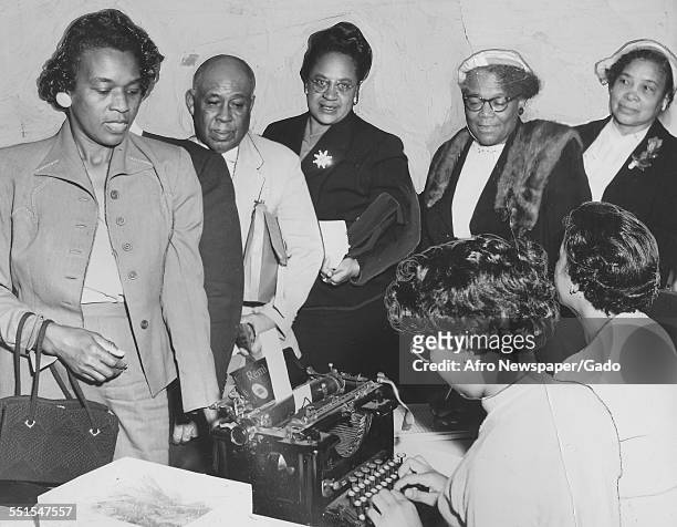 Group of African-American people, men and women, in a line registering to vote before the deadline in the presidential and congressional elections,...