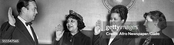 Two women being sworn in, signing up to the Rose Brigade Campaign, under the Women for Wagner slogan, to support the election of Senator Robert...