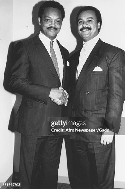 The Reverend Jesse Jackson, first black chair of the Democratic National Committee shaking hands with Ronald H Brown, on agreeing to hold a campaign...