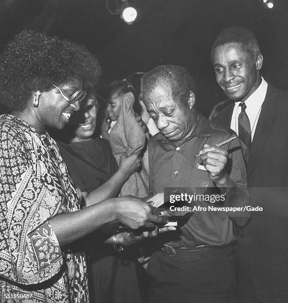 The playwright James Baldwin, author of Blues for Mr Charlie, a play in New York city, signing books for fans, with Percy Thomas the lead actor, New...