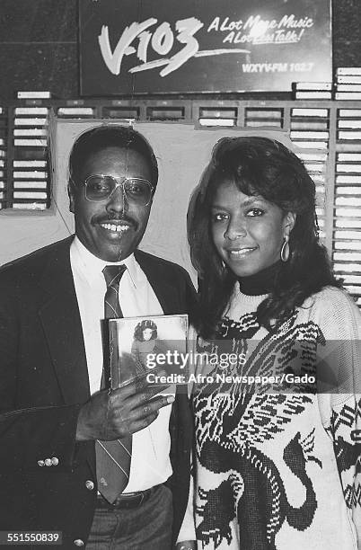 Natalie Maria Cole, African-American singer, songwriter, and performer, with Roy Sampson, the program director of V-103 radio station, November 20,...