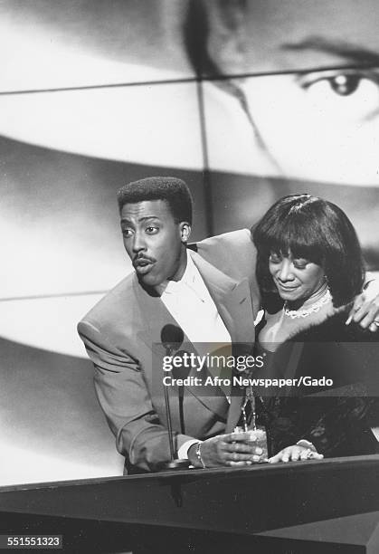 Arsenio Hall, African-American actor and comedian with a female performer, 1980.