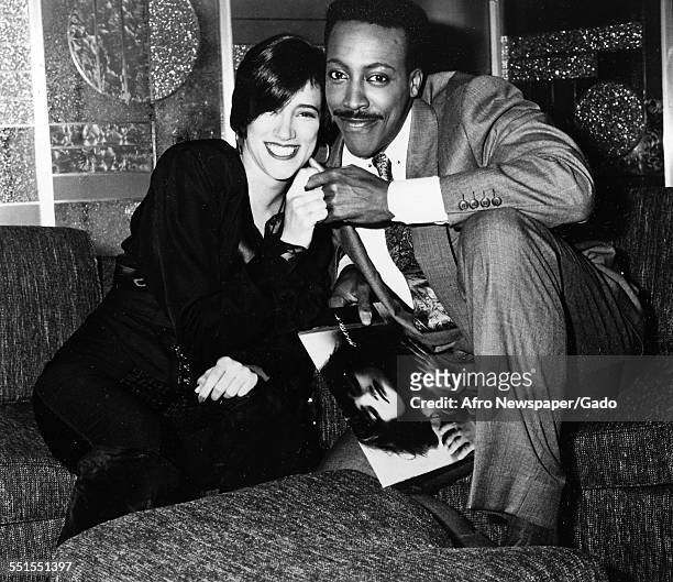 Arsenio Hall, African-American actor and comedian and a woman, May 29, 1995.