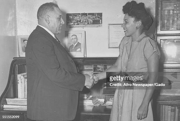 Dr Martin, owner of the Red Sox baseball team, shaking hands with Mrs Bankhead, wife of the pitcher Dan, New York City, June 9, 1947.