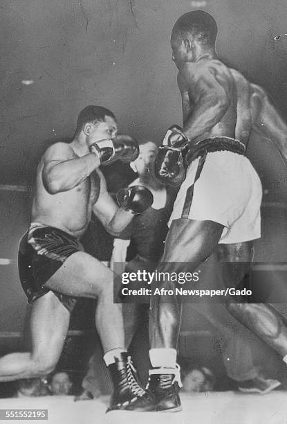 Archie Moore, African-American professional boxer and the Light Heavyweight World Champion, in the ring against Ezzard Charles, May 20, 1946.