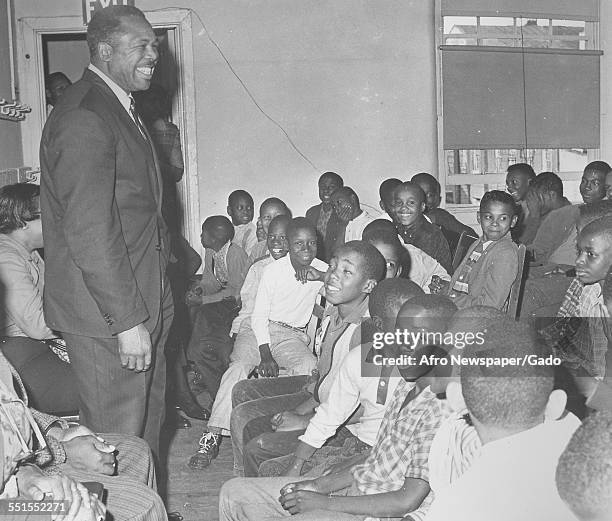 Archie Moore, African-American professional boxer and the Light Heavyweight World Champion, addressing a room full of children, December 10, 1961.