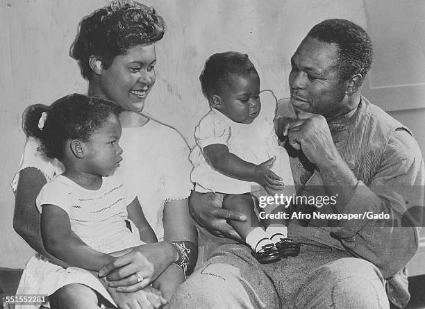 Archie Moore, African-American professional boxer and the Light Heavyweight World Champion, with his wife and two young daughters, November 6, 1960.