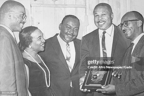 Archie Moore, African-American professional boxer and the Light Heavyweight World Champion, being given an award for social and sporting...