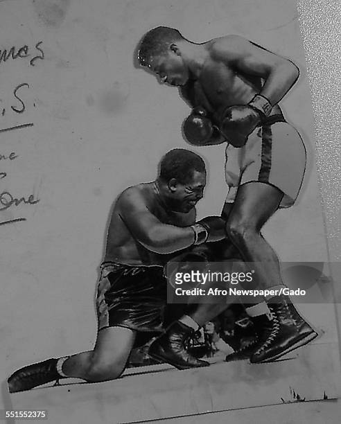 Archie Moore, African-American professional boxer and the Light Heavyweight World Champion, in fight with Floyd Patterson, November 30, 1956.
