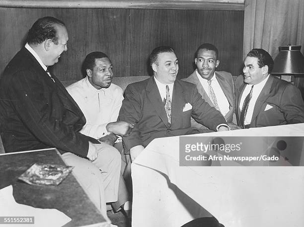Archie Moore, African-American professional boxer and the Light Heavyweight World Champion, at a Variety Club benefit in New York with Clarence...