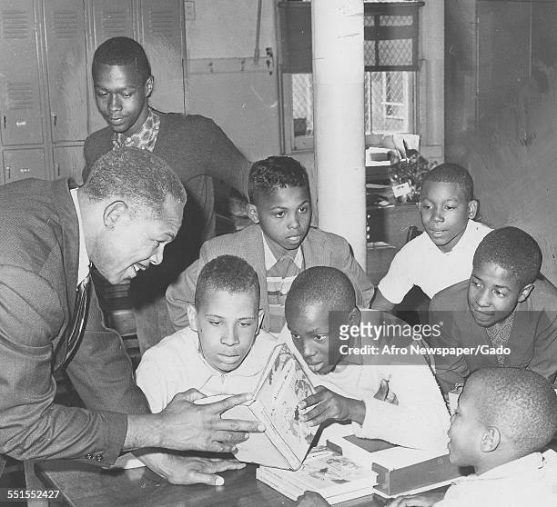 Archie Moore, African-American professional boxer and the Light Heavyweight World Champion, visiting a school, October 21, 1961.