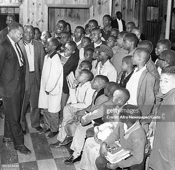 Archie Moore, African-American professional boxer and the Light Heavyweight World Champion, visiting a boys club, October 18, 1961.