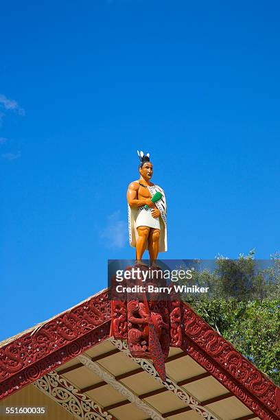 statue of maori warrior atop building - maori warrior stock pictures, royalty-free photos & images