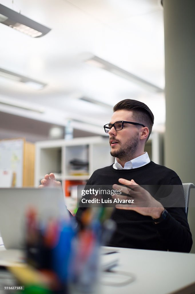 Businessman sitting at desk in office