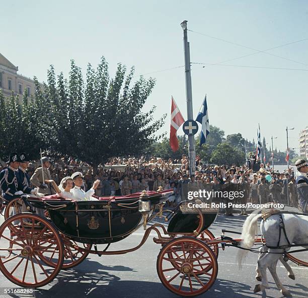 Princess Anne-Marie of Denmark travels through the streets of Athens with her father, King Frederick IX of Denmark in a horse drawn carriage on the...