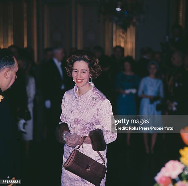 Queen Fabiola of Belgium pictured wearing a pink jacket with fur lined cuffs and matching skirt at a New Year reception at the Royal Palace in...