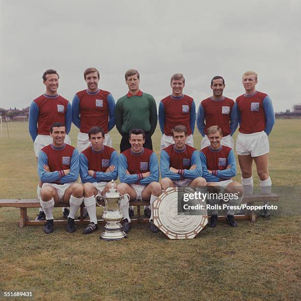 West Ham United Football squad posed during the 1964-1965 season with the Football Association Challenge Cup and the Football Association Charity...