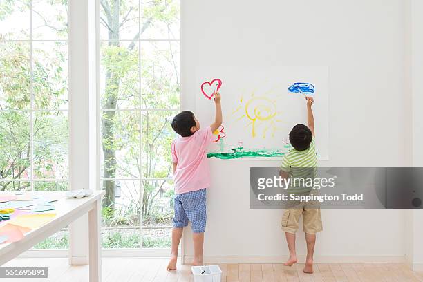 brothers painting on paper - children room wall stock pictures, royalty-free photos & images