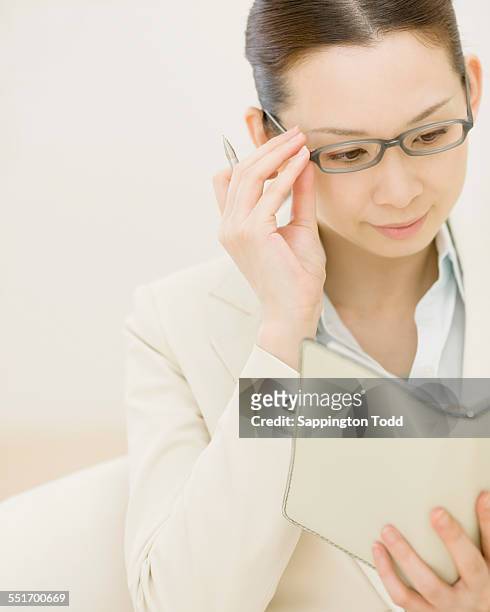 businesswoman reading diary - need reading glasses stock pictures, royalty-free photos & images