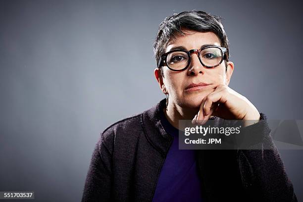 studio portrait of mature businesswoman with chin on hand - hand on chin stock pictures, royalty-free photos & images
