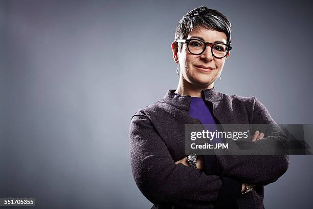 studio portrait of mature businesswoman with arms folded - low angle view stock pictures, royalty-free photos & images