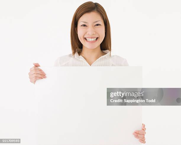 woman holding placard - ボード　持つ　女性 ストックフォトと画像