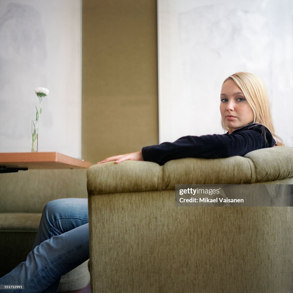 Young Woman Sitting in Armchair