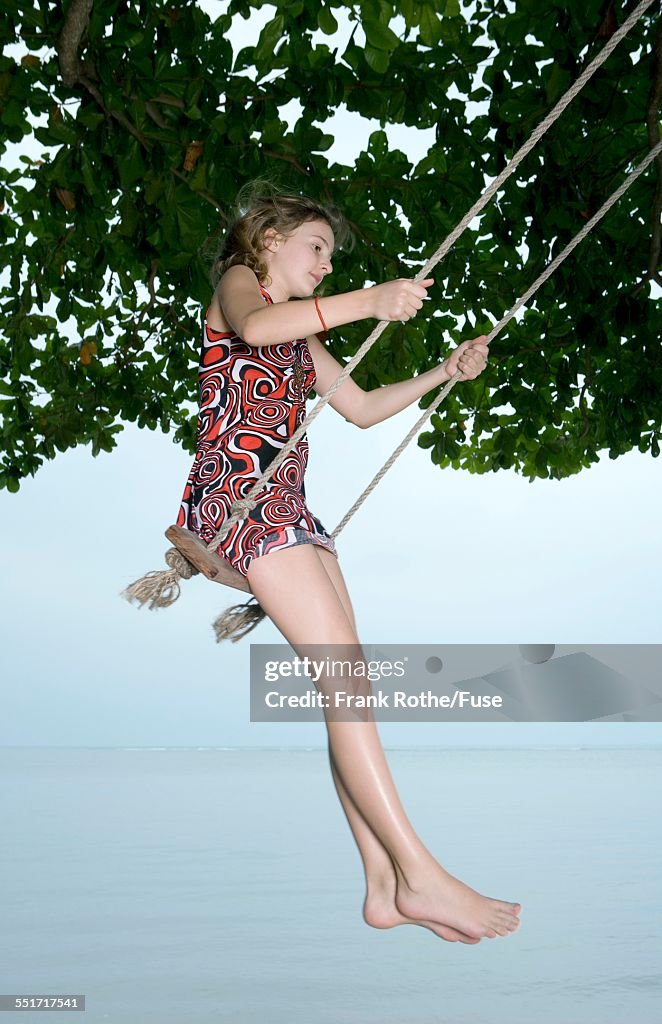 Girl Using Tree Swing at Beach