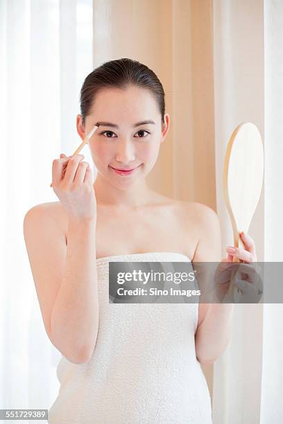 woman having beauty treatment - eyebrow pencil stockfoto's en -beelden