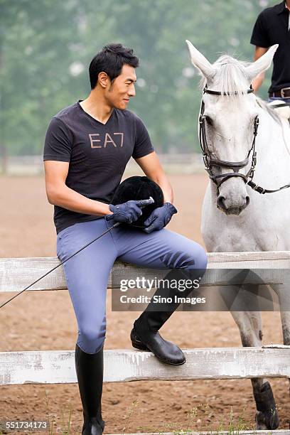 young man with a horse - 馬の衣装 ストックフォトと画像