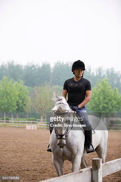 young man riding a horse - 馬の衣装 ストックフォトと画像