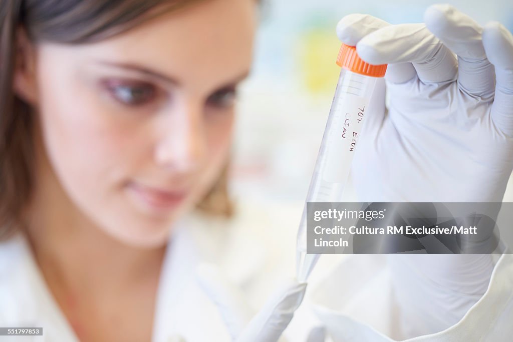 Female science student looking at test tube