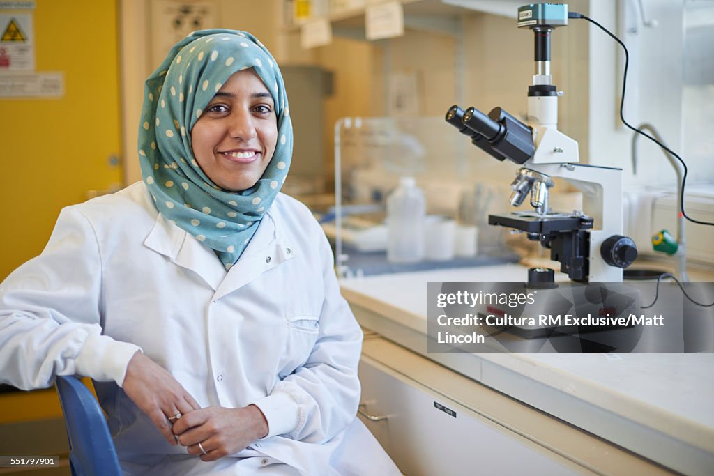 Portrait of a female science student with microscope