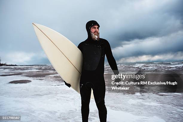 surfer standing in lake ontario in winter - frozen beard stock pictures, royalty-free photos & images