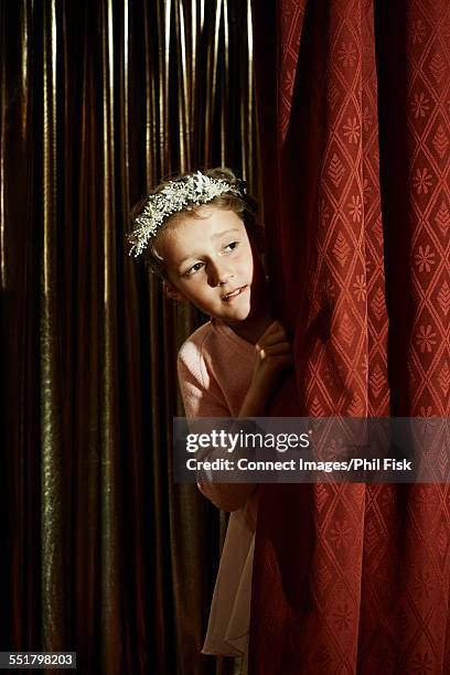 girl with head wreath behind stage curtain - peça de teatro escolar imagens e fotografias de stock