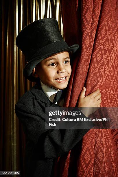 boy in top hat behind stage curtain - bad actor stock pictures, royalty-free photos & images