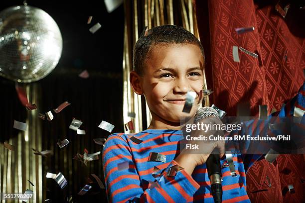 boy with microphone waving on stage - recita della scuola foto e immagini stock