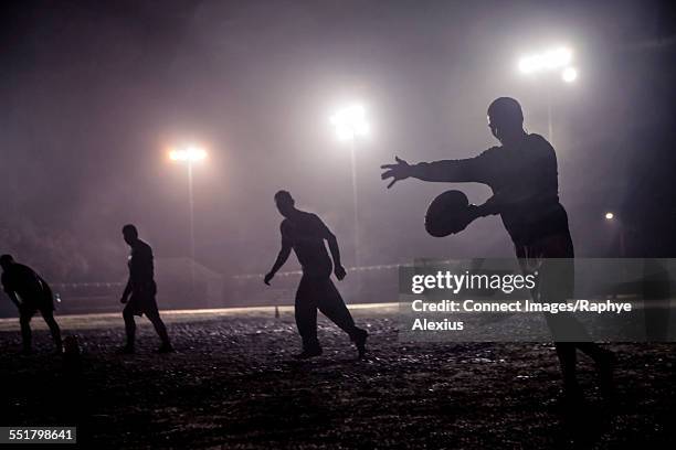 rugby drop kick on muddy field - rugby silhouette fotografías e imágenes de stock