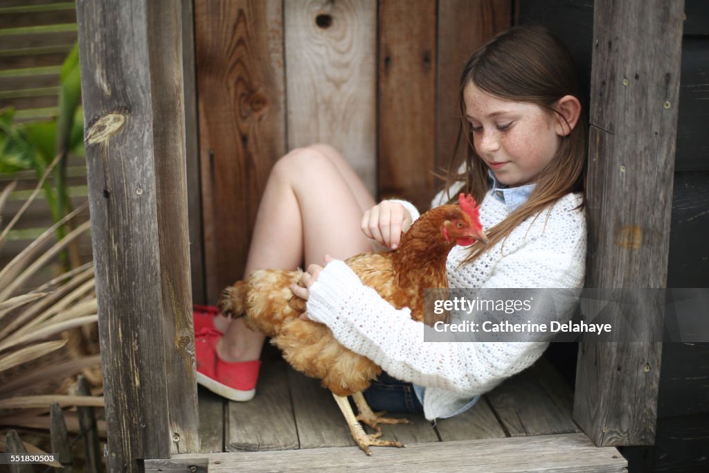 A girl with a chicken