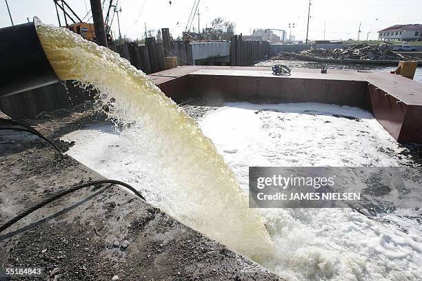 Metairie, UNITED STATES: Water is pumped 06 September 2005 in Metairie, Louisiana near New Orleans eight days after Hurricane Katrina devastated the...