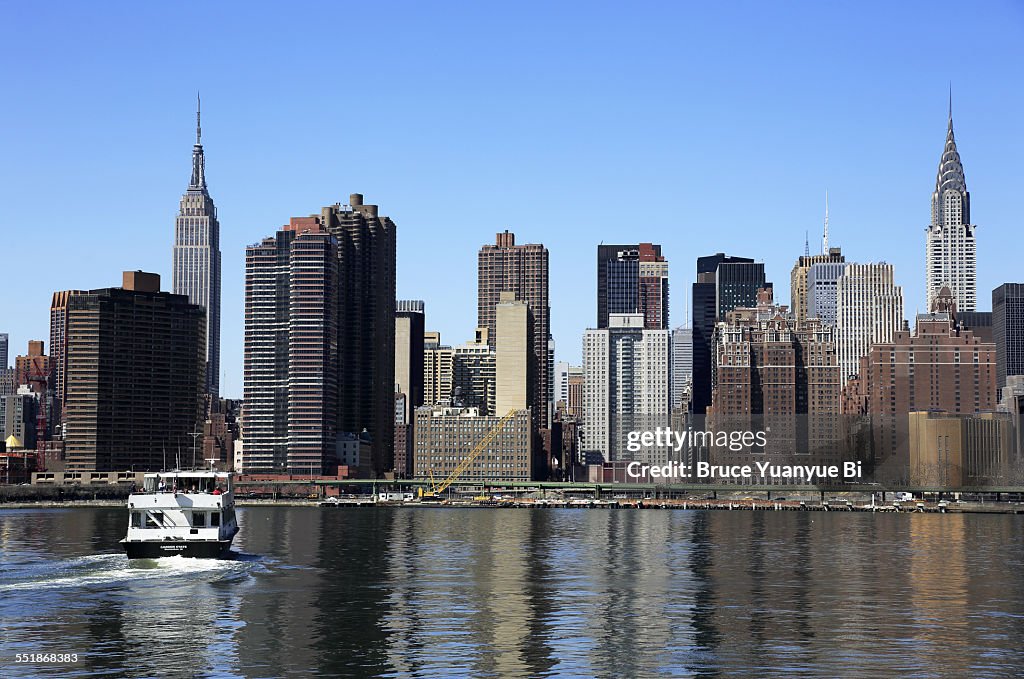 Manhattan skyline with ferry in East River